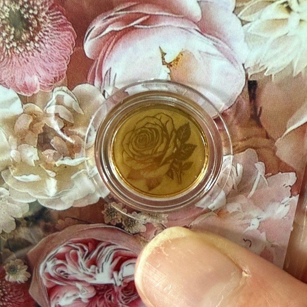 4 - 1/1000 oz flower gold coin.